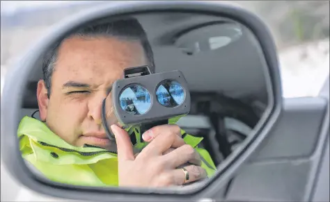  ?? ASHLEY THOMPSON ?? Sgt. Andrew Buckle with the RCMP uses a LIDAR to catch speeders in the Annapolis Valley of Nova Scotia.