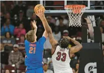  ?? ?? Josh Gray deflects a shot attempt by Florida big man Alex Condon in Saturday’s game in Columbia between ranked teams.