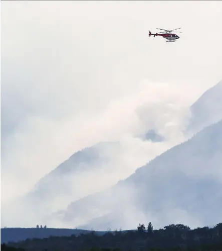  ?? JIM WELLS ?? Plumes of smoke rise near Waterton on Wednesday south of Pincher Creek. Cooler temperatur­es helped reduce the fire risk.