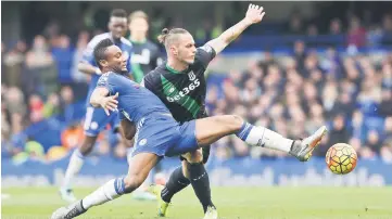  ??  ?? Chelsea’s John Obi Mikel in action with Stoke’s Marko Arnautovic. — Reuters photo