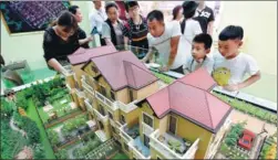  ?? PROVIDED TO CHINA DAILY ?? Visitors check out a property project at a housing fair in Luoyang, Henan province.