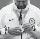  ?? AP ?? John Shuster holds his gold medal after helping Team USA win the men’s Olympic curling tournament.
