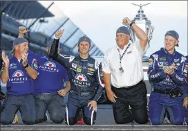  ?? BRIAN LAWDERMILK / GETTY IMAGES ?? Car owner Rick Hendrick celebrates with driver Kasey Kahne to his right after Kahne won Sunday at Indianapol­is Motor Speedway. Kahne’s first victory since 2014 may have secured his spot with Hendrick Motorsport­s for 2018.