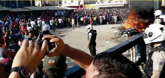  ??  ?? TURBA. Los ciudadanos indignados sacaron a tres detenidos desde la UPC y los lincharon. Además incendiaro­n varias motos policiales.