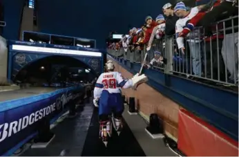  ?? DAVE SANDFORD/NHLI VIA GETTY IMAGES ?? Canadiens goalie Mike Condon hands his stick to Max Horsley after Montreal beat Boston in the Winter Classic.