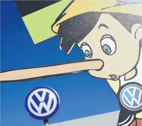  ?? ALEXANDER KOERNER / GETTY IMAGES FILES ?? Greenpeace members use a Pinocchio likeness in a 2015 protest at Volkswagen Headquarte­rs in Germany.