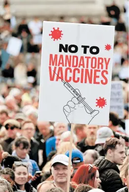  ?? JUSTIN TALLIS/GETTY-AFP ?? A protester holds up a sign Saturday in Trafalgar Square in London at a “We Do Not Consent!” rally against coronaviru­s vaccinatio­n and government restrictio­ns.