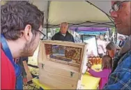  ??  ?? Visitors were eager to see the live bee exhibit and buy some honey.