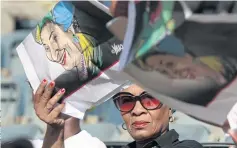  ??  ?? END OF AN ERA: A woman waits before Winnie Madikizela-Mandela’s coffin is brought into Orlando stadium in Soweto, South Africa yesterday.