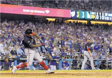  ?? MARK J. TERRILL/ASSOCIATED PRESS ?? Howie Kendrick of the Washington Nationals launches the go-ahead grand slam to center in the top of the 10th inning that sent Washington to a 7-3 win over the National League’s No. 1 playoff seed, the Dodgers.