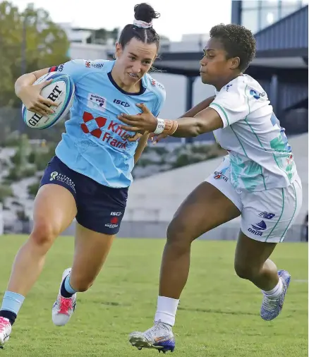  ?? Photo: Waratahs Rugby Media ?? Rooster Chicken Fijiana Drua winger Adita Milinia tries to tackle a NSW Waratahs player during their Super W semifinal match on April 30, 2023.