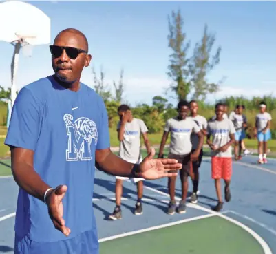  ?? JOE RONDONE/THE COMMERCIAL APPEAL ?? Memphis Tigers coach Penny Hardaway kicks off a basketball clinic for young children at the Bozine Town Community Park in Nassau, Bahamas on Friday.