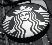  ?? ASSOCIATED PRESS ?? THIS JUNE 26 FILE PHOTO SHOWS A STARBUCKS sign outside a Starbucks coffee shop in downtown Pittsburgh. The coffee chain will quit selling major newspapers in September, citing “changing customer behavior.”