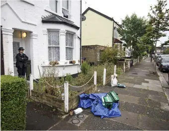  ?? Picture: BEN CAWTHRA/LNP ?? An officer stands guard, with medical equipment piled up on the street in Enfield yesterday
