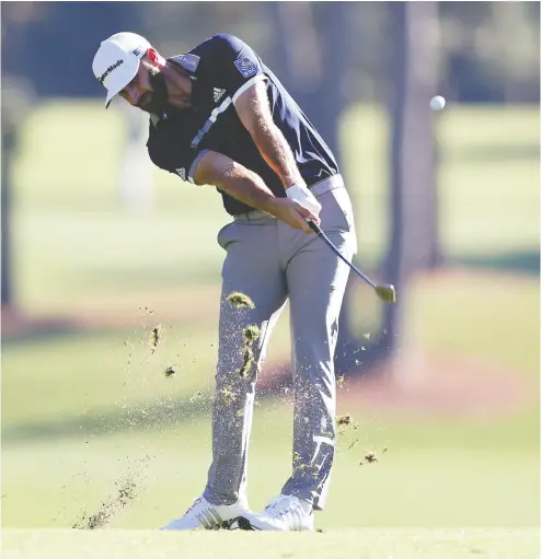  ?? Rob Carr / Gett y Imag es ?? Dustin Johnson of the United States plays a shot on the eighth hole during the second round of the Masters.