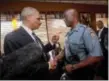  ?? PABLO MARTINEZ MONSIVAIS — THE ASSOCIATED PRESS ?? Attorney General Eric Holder talks with Capt. Ron Johnson of the Missouri State Highway Patrol at Drake’s Place Restaurant in Florrissan­t, Mo.