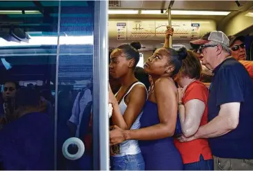  ?? Annie Mulligan photos ?? Metro trains already packed with riders leave no room Friday for the hundreds of people waiting in line at the Fannin South Transit Center hoping to catch a free ride downtown for the Astros’ championsh­ip parade.