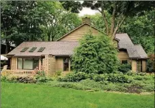  ??  ?? Patio doors from the breakfast room and the sun room open to the wrap-around wooden deck with built-in bench seats. The main bedroom has access to a covered balcony, a bonus room and an updated full bathroom.