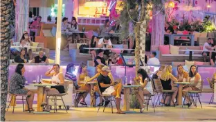  ??  ?? Open touristic bars are seen amid the COVID-19 outbreak in Palma de Mallorca, Spain, in July. Psychologi­sts say COVID-19 is exacerbati­ng a human tendency to break the rules. ENRIQUE CALVO • REUTERS