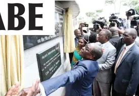  ??  ?? President Mugabe unveils a plaque to mark the official renaming of the Harare Internatio­nal Airport to Robert Gabriel Mugabe Internatio­nal Airport in his honour in Harare yesterday. Flanking him is Transport and Infrastruc­tural Developmen­t Minister Dr...