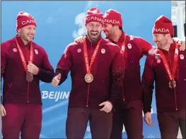  ?? AP PHOTO PAVEL GOLOVKIN ?? Justin Kripps, Ryan Sommer, Cam Stones and Benjamin Coakwell, of Canada, celebrate winning the bronze medal in the 4-man at the 2022 Winter Olympics, Sunday, Feb. 20, 2022, in the Yanqing district of Beijing.