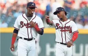  ?? BRETT DAVIS/USA TODAY SPORTS ?? Ronald Acuna Jr., left, had raised his batting average to .260 and Ozzie Albies, right, was second in home runs in the NL with 14.