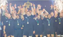  ?? PHOTO / BRETT PHIBBS ?? Richie McCaw holds aloft the Webb Ellis Cup after the All Blacks’ World Cup triumph in 2015.