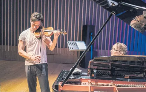  ??  ?? FASHION ICON: Charlie Siem, the violin virtuoso, rehearses with Alison Rhind in London. ‘My great love is my music,’ he says.