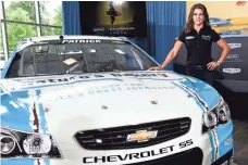  ?? JARED C. TILTON, GETTY IMAGES, FOR STEWART-HAAS RACING ?? Danica Patrick stands Tuesday next to her No. 10 Chevrolet featuring the logos of new sponsor Nature’s Bakery.