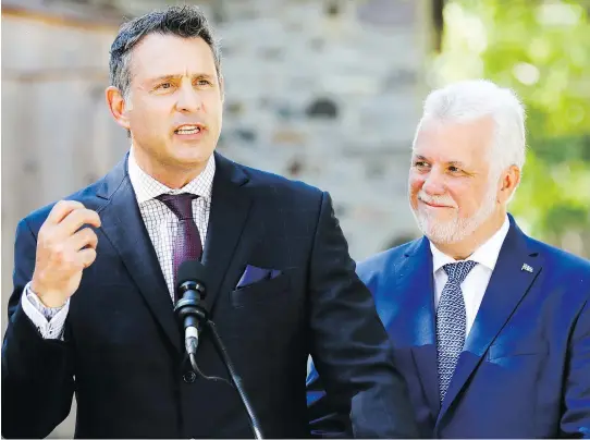  ?? JOHN MAHONEY ?? Premier Philippe Couillard introduced former NHL enforcer Enrico Ciccone, left, as the Marquette candidate on Thursday. “I want to make people’s lives better,” Ciccone says.