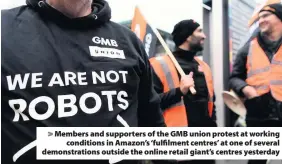  ??  ?? &gt; Members and supporters of the GMB union protest at working conditions in Amazon’s ‘fulfilment centres’ at one of several demonstrat­ions outside the online retail giant’s centres yesterday