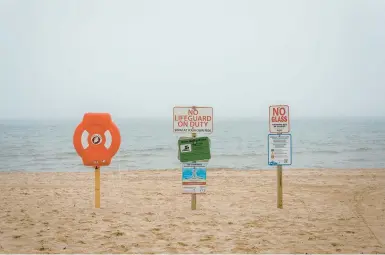  ?? JAMIE KELTER DAVIS/THE NEW YORK TIMES ?? A sign warns there are no lifeguards are on duty June 7 at Bradford Beach, in Milwaukee, Wisconsin.