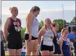  ?? CHRIS LILLSTRUNG — THE NEWS-HERALD ?? Madison’s Becca Martin, right, laughs with teammate Maddie Moretti, center, on the podium for girls shot put during Day 1 of the Division I Austintown-Fitch Regional track and field meet.