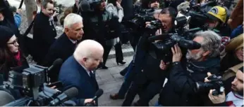  ?? SEAN KILPATRICK/THE CANADIAN PRESS ?? The media surround Mike Duffy, bottom, and his lawyer Donald Bayne as they arrive at the courthouse.