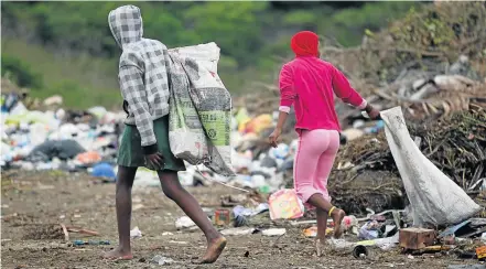  ?? Picture: MICHAEL PINYANA ?? RECYCLING: Children are seen here at Second Creek dump site where they get material to recycle, from bricks to plastic, cans and other things they can sell to chase the wolf from the door