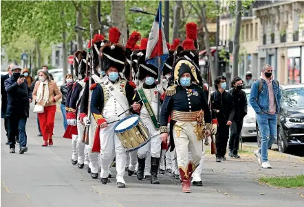  ?? GETTY IMAGES ?? Historical re-enactors parade past the Hotel des Invalides in Paris on the two hundredth anniversar­y of the death of Napoleon Bonaparte.