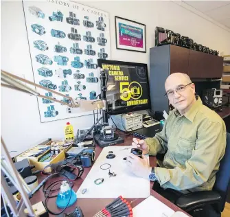  ??  ?? Repair technician Mark Langer at Victoria Camera Service. “We are one of the few places left in Canada.”