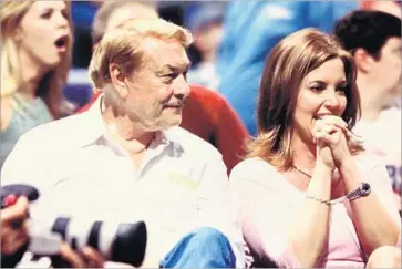  ?? Buss family ?? JEANIE BUSS sits courtside with her father, Jerry, who died in 2013. “For me, the burning desire has always been about building what my family had,” she said. “Making it better and keeping it healthy and strong.”