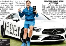  ??  ?? Roger Federer poses after winning the Stuttgart Open. — AFP