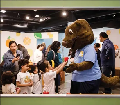  ?? DAI SUGANO/BAY AREA NEWS GROUP ?? Potter the Otter interacts with children during the opening ceremony for the new exhibit, “Potter the Otter: A Healthy Adventure,” at the Children’s Discovery Museum of San Jose, on Feb. 21.