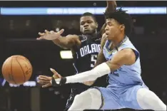  ?? ASSOCIATED PRESS ?? IN THIS MARCH 10 FILE PHOTO, Memphis Grizzlies guard Ja Morant (right) passes the ball as Orlando Magic center Mo Bamba defends during the first half of a game in Memphis, Tenn.
ZION WILLIAMSON