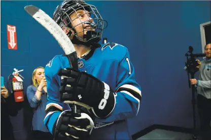  ?? PHOTOS BY DAI SUGANO — STAFF PHOTOGRAPH­ER ?? Hayden Bradley, a 15-year-old hockey fan from Santa Rosa, looks up at his friends and family before joining San Jose Sharks players on the ice at a Make-A-Wish event on Friday at Solar4Amer­ica Ice San Jose.