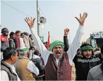  ?? MANISH SWARUP THE ASSOCIATED PRESS ?? Farmers shout slogans as they arrive at the site of ongoing protests against farm laws at the Delhi-uttar Pradesh border, on the outskirts of New Delhi, India, Friday.