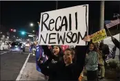  ?? MARCIO JOSE SANCHEZ — THE ASSOCIATED PRESS FILE ?? Trump supporters shout slogans while carrying a sign calling for a recall of Gov. Gavin Newsom during a protest against a stay-at-home order in Huntington Beach.