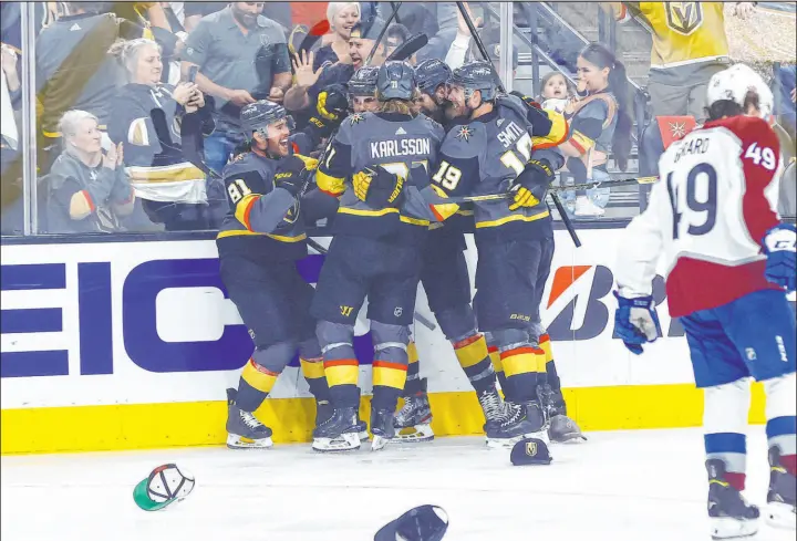  ?? Las Vegas Review-journal @csstevensp­hoto ?? Chase Stevens
Golden Knights forward Jonathan Marchessau­lt, left, is mobbed by teammates after scoring a hat trick in the third period Sunday at T-mobile Arena. Max Pacioretty and Patrick Brown also had goals for the Knights, who scored five unanswered after falling behind early in the first period. The series shifts to Denver for Game 5 on Tuesday.