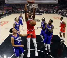  ?? AP Photo/Marcio Jose Sanchez ?? Sacramento Kings’ Harry Giles II (center) dunks against the Los Angeles Clippers during the first half of an NBA basketball game on Saturday in Los Angeles.