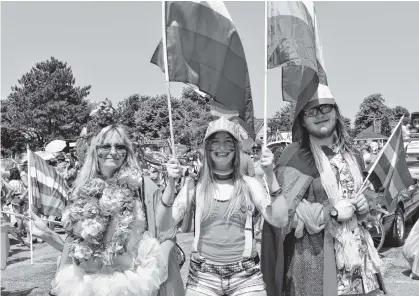  ?? MICHAEL ROBAR/THE GUARDIAN ?? Ivory Jansen, centre, waits with her mom Angel and brother Drake for the Charlottet­own Pride Parade to start on Saturday.