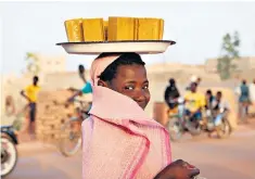  ??  ?? Setting the bars high: a woman carrying soap in the Niger Delta town of Mopti, Mali