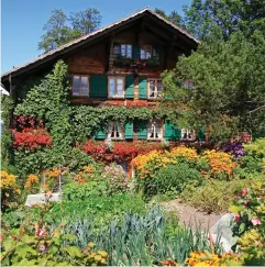  ??  ?? Idyll? A traditiona­l Swiss chalet and a garden in bloom