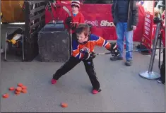  ?? NEWS PHOTO MO CRANKER ?? Ethan Chenard tees up a slapshot Saturday afternoon in an attempt to win the hardest shot competitio­n during the Rogers Hometown Hockey event.